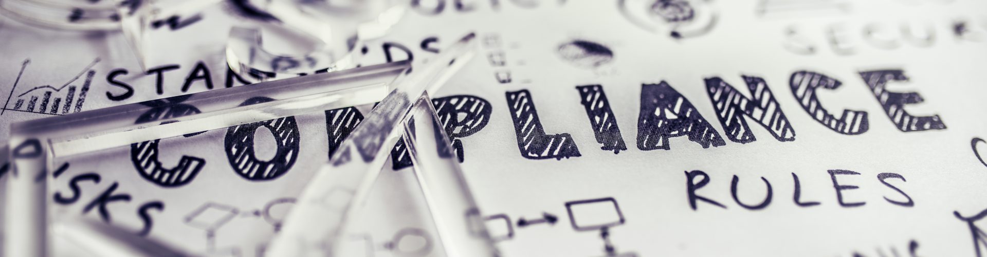 Transparent check mark over compliance related icons and words handwritten on white papers