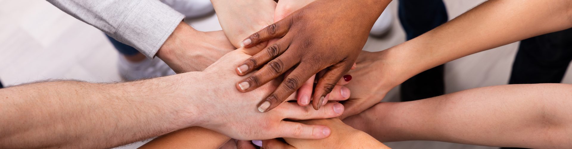 High Angle View Of Multiracial Friend Stacking Hand Together