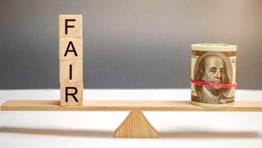 Dollars and the inscription Fair on wooden blocks. Balance. Fair value pricing, money debt. Fair deal. Reasonable price. Justified risk. Honest loan. Secured loans.