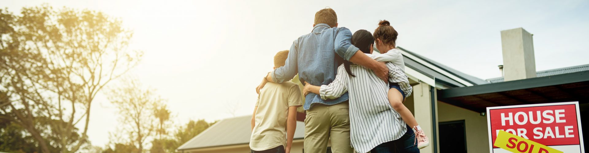 Shot of a family of four viewing their new home together