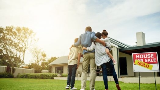 Shot of a family of four viewing their new home together