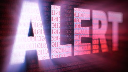 ALERT bright glowing word on computer screen filled with red binary code