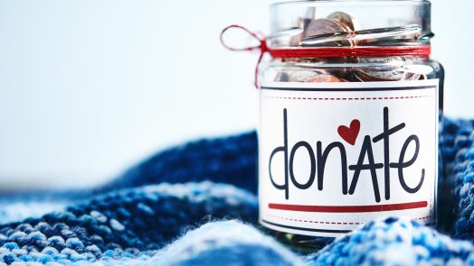 Donation money jar filled with coins