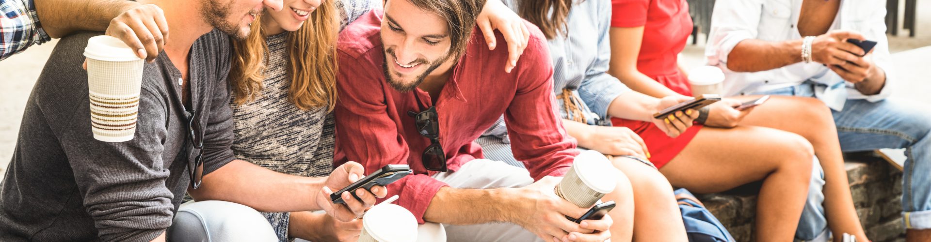 Multiracial millennials group using smart phone at city college backyard - Young people addicted by mobile smartphone - Technology concept with connected trendy friends - Warm vibrance sunshine filter
