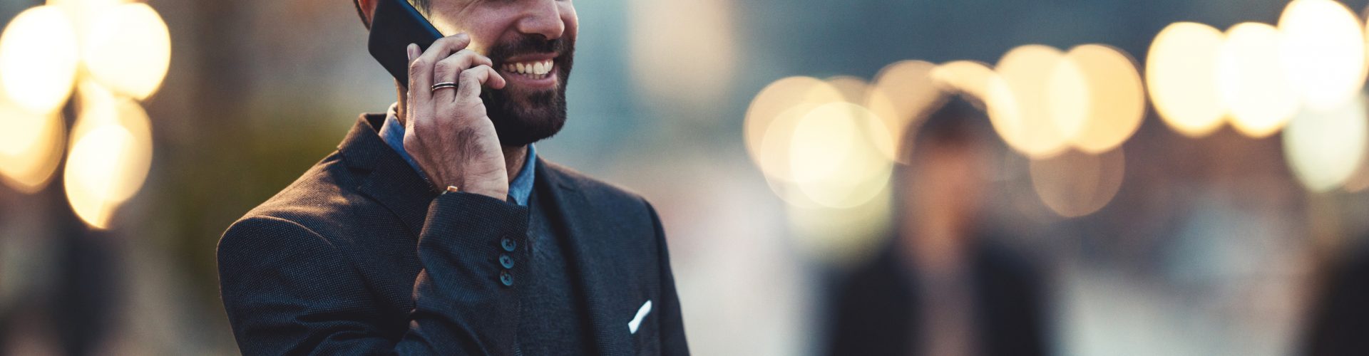 Side view of a young businessman talking on the cellphone.
