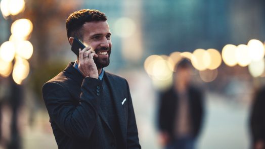 Side view of a young businessman talking on the cellphone.
