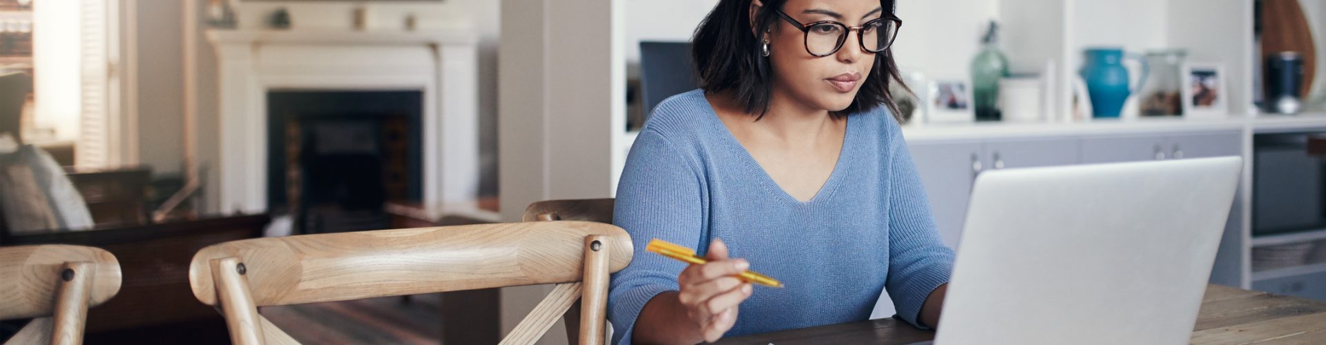 Shot of a young woman using a laptop while working from home