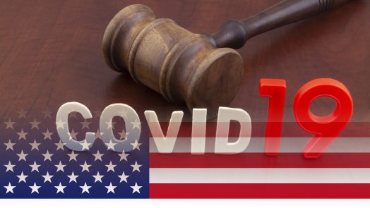 Wooden judge gavel with letters covid19 on table and usa flag. Concept of quarantine and law against covid-19.