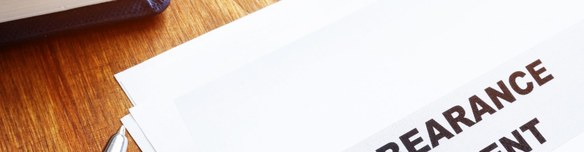 Forbearance agreement papers with pen and notepad.
