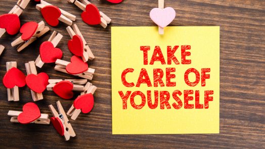 Take care of yourself. Healthy lifestyle, security, retirement and finances concept. Wooden clips with heart and note on wooden table