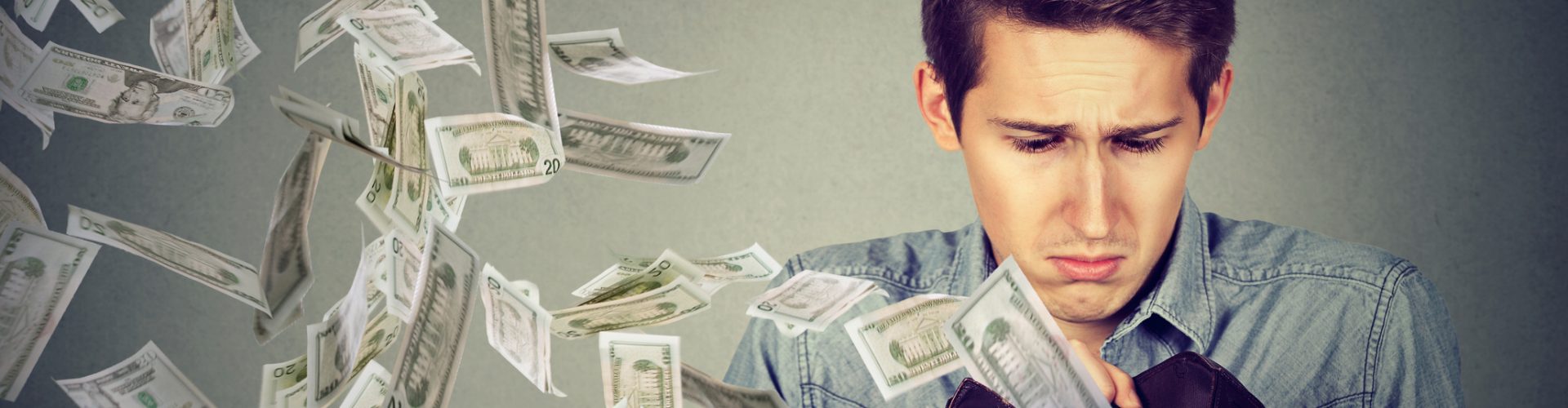 Man looking at wallet with money dollars flying away